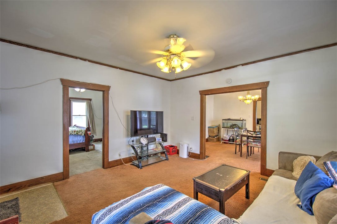 739 West Cushing Street Decatur, IL 62526 - Photo 9 of 28 a living room with furniture a chandelier and a flat screen tv