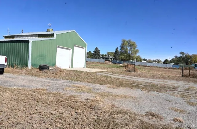 a backyard of a house with lots of green space and trees