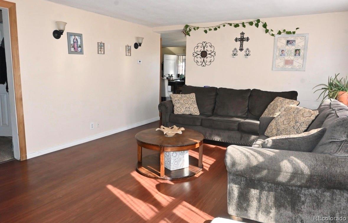 7992 County Road 31 Fort Lupton, CO 80621 - Photo 6 of 14 a living room with furniture and wooden floor
