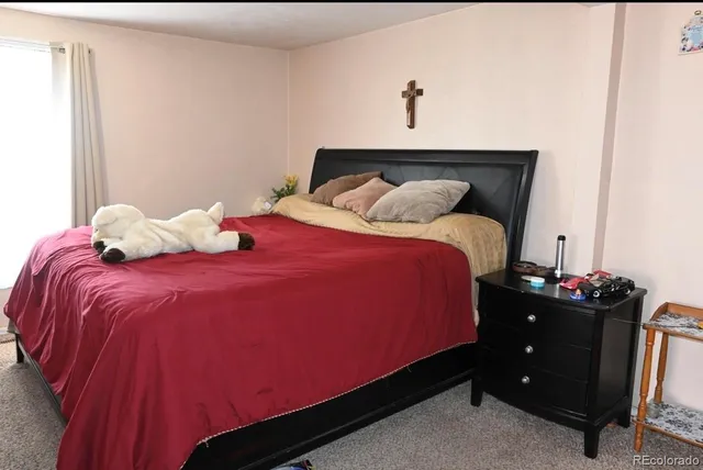 a bedroom with a bed and a night stand