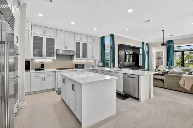 a living room with furniture a flat screen tv and a large window