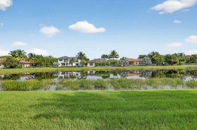 an aerial view of a house with a yard and lake view