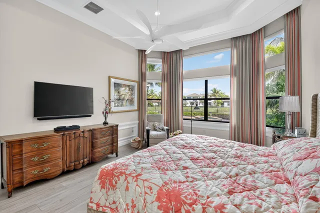 a front view of a house with a yard and palm trees