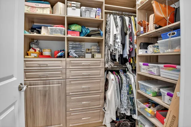 a very nice looking room with a large bed a chandelier and couches