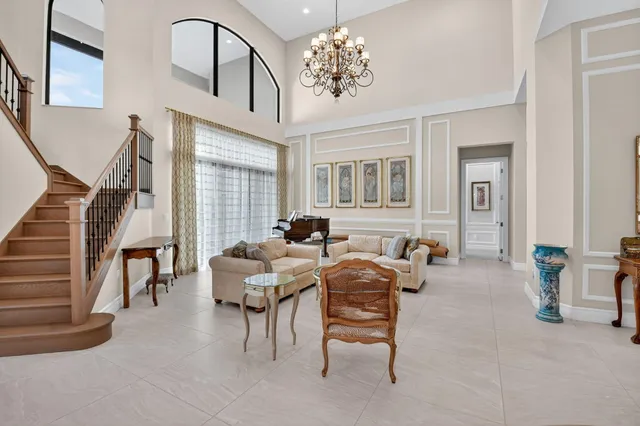 a living room with furniture and a glass door