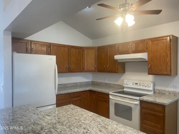 a kitchen with a stove and a refrigerator