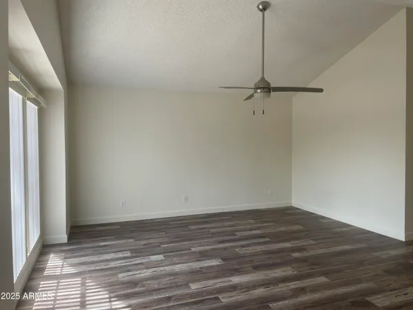 a view of a room with wooden floor and a window