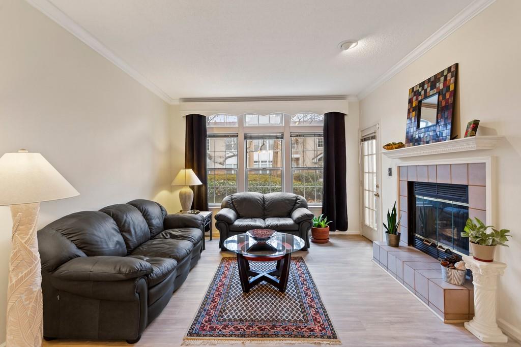 Large living room with gas fireplace and direct access to patio. Oversized windows provide lots of natural sunlight.