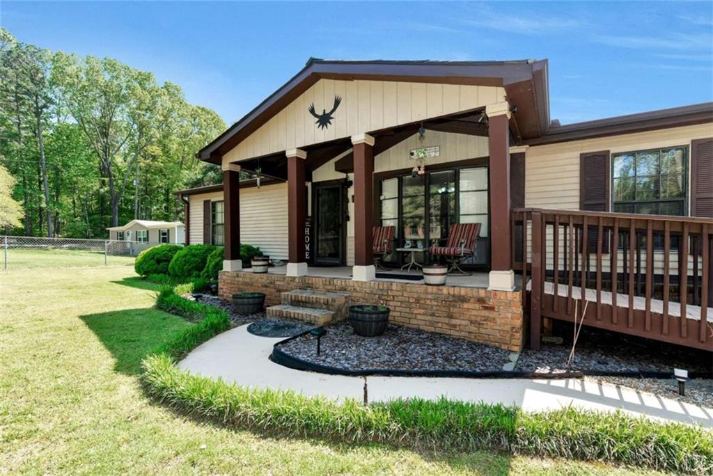 a view of a house with backyard porch and sitting area