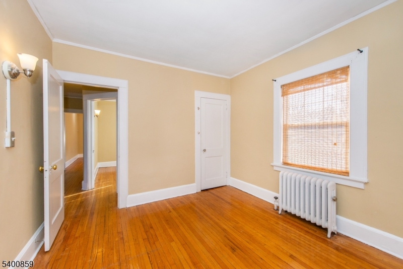 422 Valley Road, Unit 1 Montclair, NJ 07043 - Photo 17 of 24 an empty room with wooden floor and windows