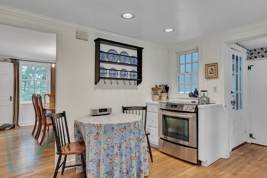 25 Fair Oaks Drive Lexington, MA 02421 - Photo 11 of 27 a kitchen with stainless steel appliances granite countertop a stove top oven a sink a dining table and chairs