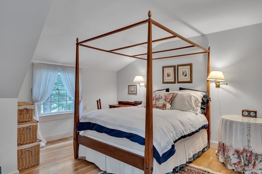25 Fair Oaks Drive Lexington, MA 02421 - Photo 17 of 27 a bedroom with a bed and a chandelier