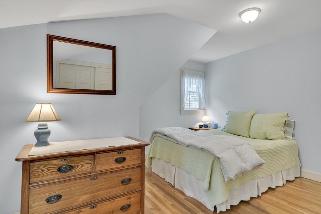 25 Fair Oaks Drive Lexington, MA 02421 - Photo 20 of 27 a bedroom with a bed and a lamp on table