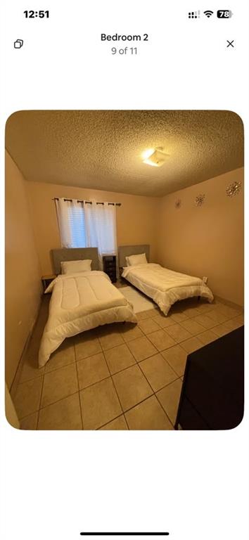 5615 Harvest Hill Road, Unit 2015 Dallas, TX 75230 - Photo 5 of 9 a bedroom with a bed