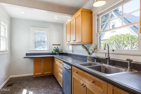 a kitchen with a sink a counter top space and cabinets