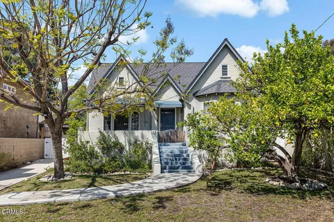 a view of a house with a tree in front