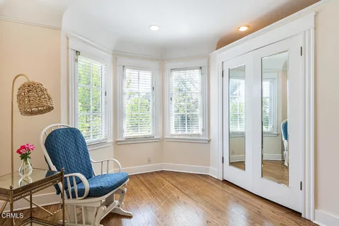a view of a workspace with furniture and a window