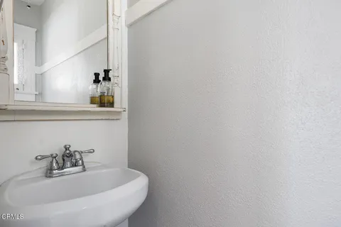 a bathroom with a sink and mirror