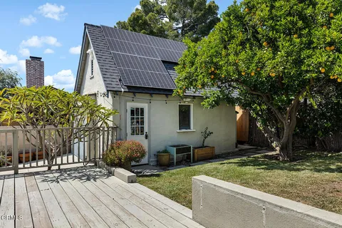 a front view of house with yard and trees around
