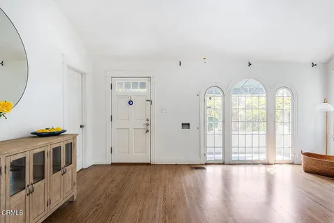 a view of an empty room with glass door and entryway