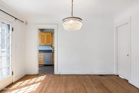 a view of room with window and wooden floor