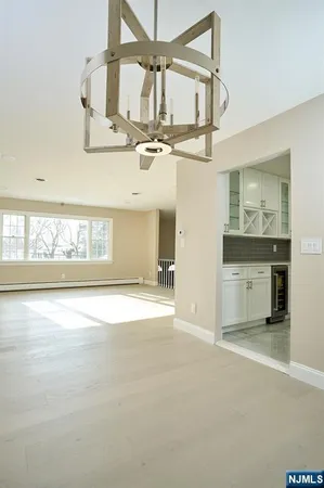 a large kitchen with a table and chairs
