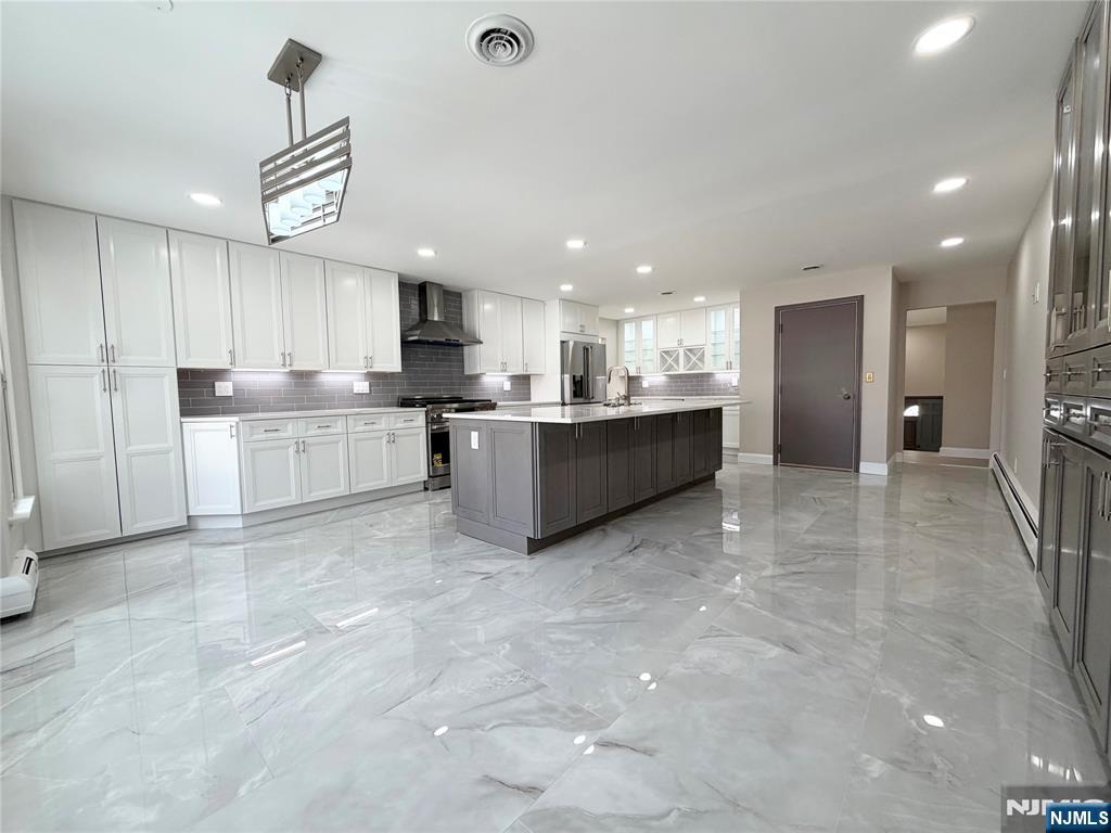 850 Ridgewood Avenue Oradell, NJ 07649 - Photo 25 of 48 a large kitchen with kitchen island a sink stainless steel appliances and a counter top