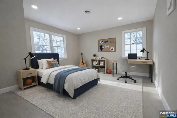 a spacious bedroom with a bed and window