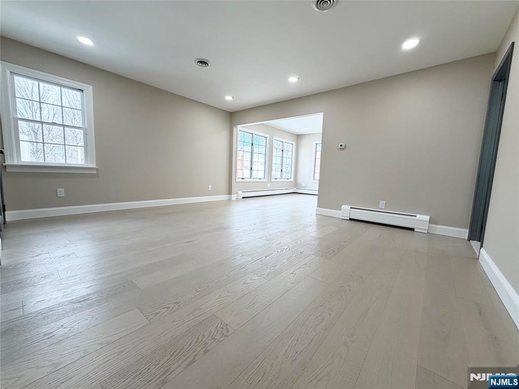 850 Ridgewood Avenue Oradell, NJ 07649 - Photo 35 of 48 an empty room with wooden floor and windows
