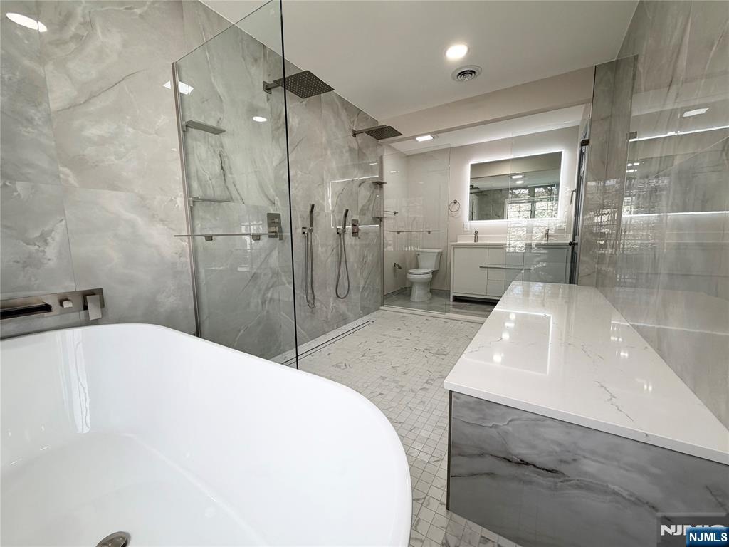 850 Ridgewood Avenue Oradell, NJ 07649 - Photo 43 of 48 a bathroom with a tub a sink and glass door shower