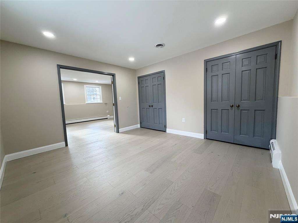 850 Ridgewood Avenue Oradell, NJ 07649 - Photo 7 of 48 an empty room with wooden floor and windows