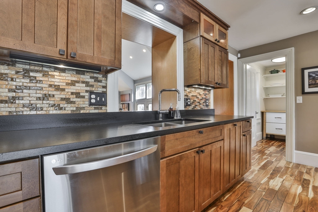 630 Brush Hill Road Milton, MA 02186 - Photo 15 of 41 a kitchen with stainless steel appliances granite countertop a sink and cabinets