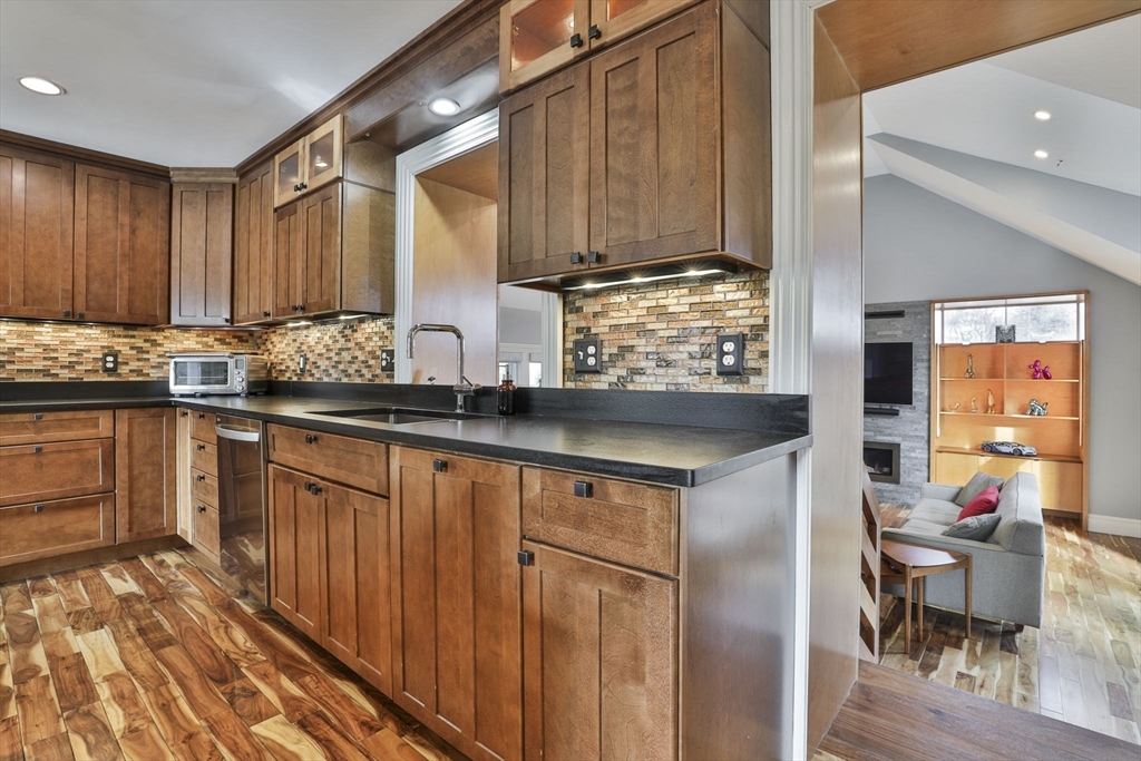 630 Brush Hill Road Milton, MA 02186 - Photo 18 of 41 a kitchen with stainless steel appliances granite countertop wooden cabinets a sink and dishwasher