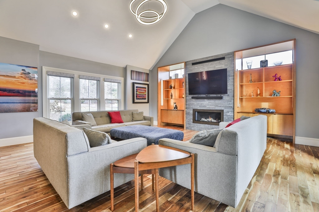 630 Brush Hill Road Milton, MA 02186 - Photo 19 of 41 a living room with fireplace furniture and a flat screen tv