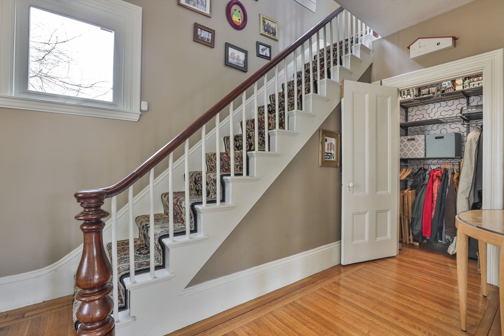 630 Brush Hill Road Milton, MA 02186 - Photo 28 of 41 a view of hallway with wooden floor and stairs