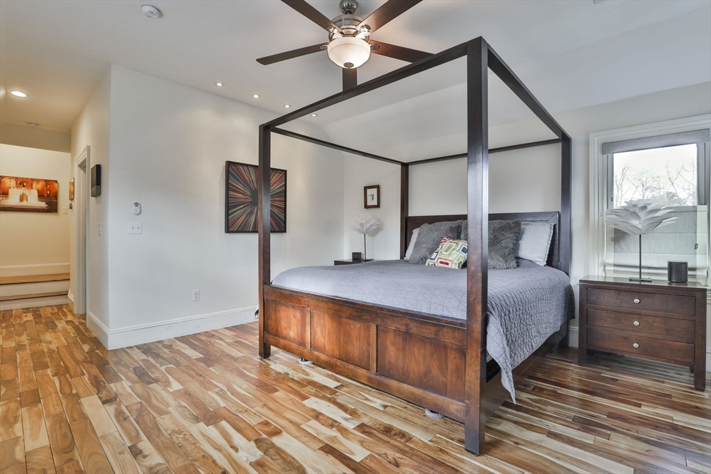 630 Brush Hill Road Milton, MA 02186 - Photo 30 of 41 a bedroom with a bed and a chandelier