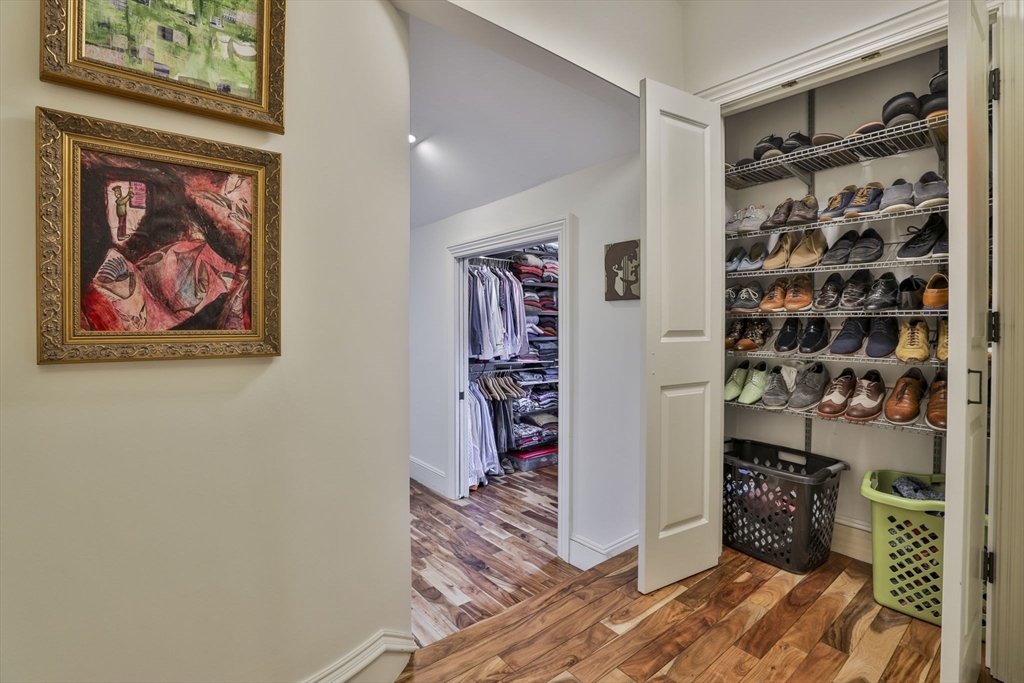 630 Brush Hill Road Milton, MA 02186 - Photo 32 of 41 a view of a hallway with wooden floor and closet