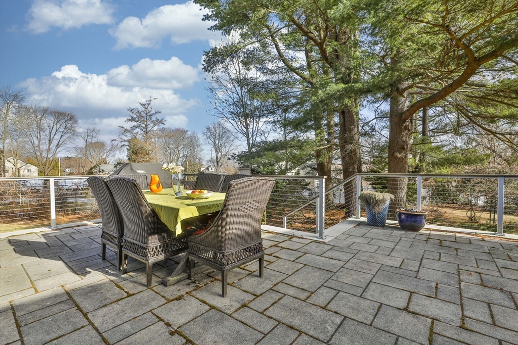 630 Brush Hill Road Milton, MA 02186 - Photo 41 of 41 a view of a patio with table and chairs and wooden fence