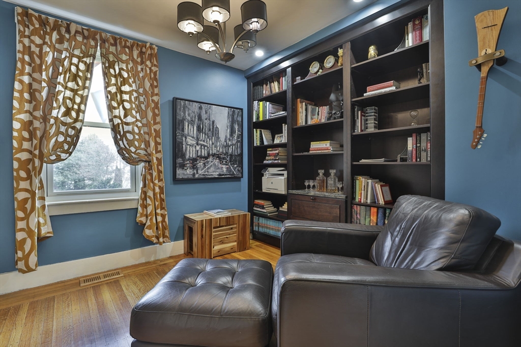 630 Brush Hill Road Milton, MA 02186 - Photo 9 of 41 a living room with furniture and a large window with bookshelf