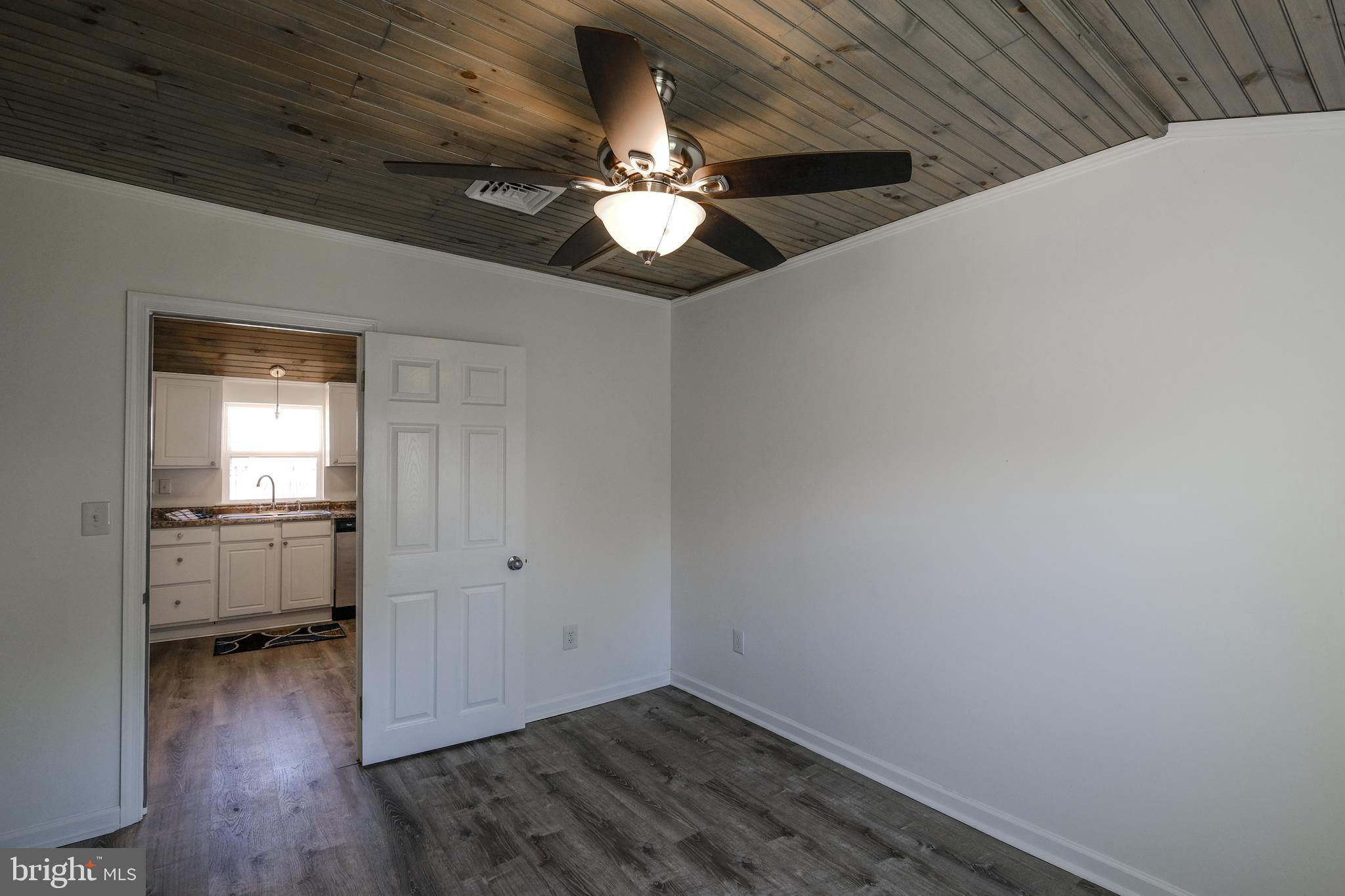 1542 Senseny Road Winchester, VA 22602 - Photo 12 of 23 a view of a livingroom with a ceiling fan and wooden floor