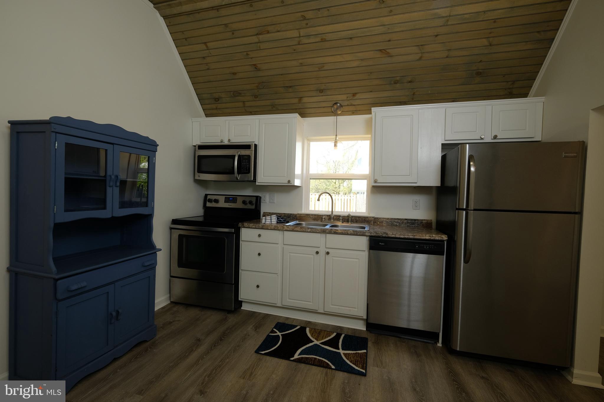 1542 Senseny Road Winchester, VA 22602 - Photo 7 of 23 a kitchen with a refrigerator stove and wooden floor