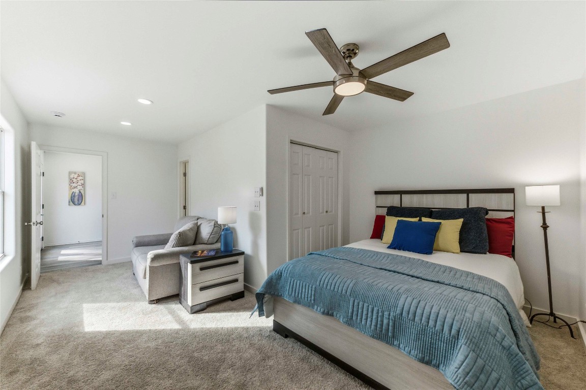 7309 Blessing Avenue Austin, TX 78752 - Photo 12 of 23 a bedroom with a bed and ceiling fan