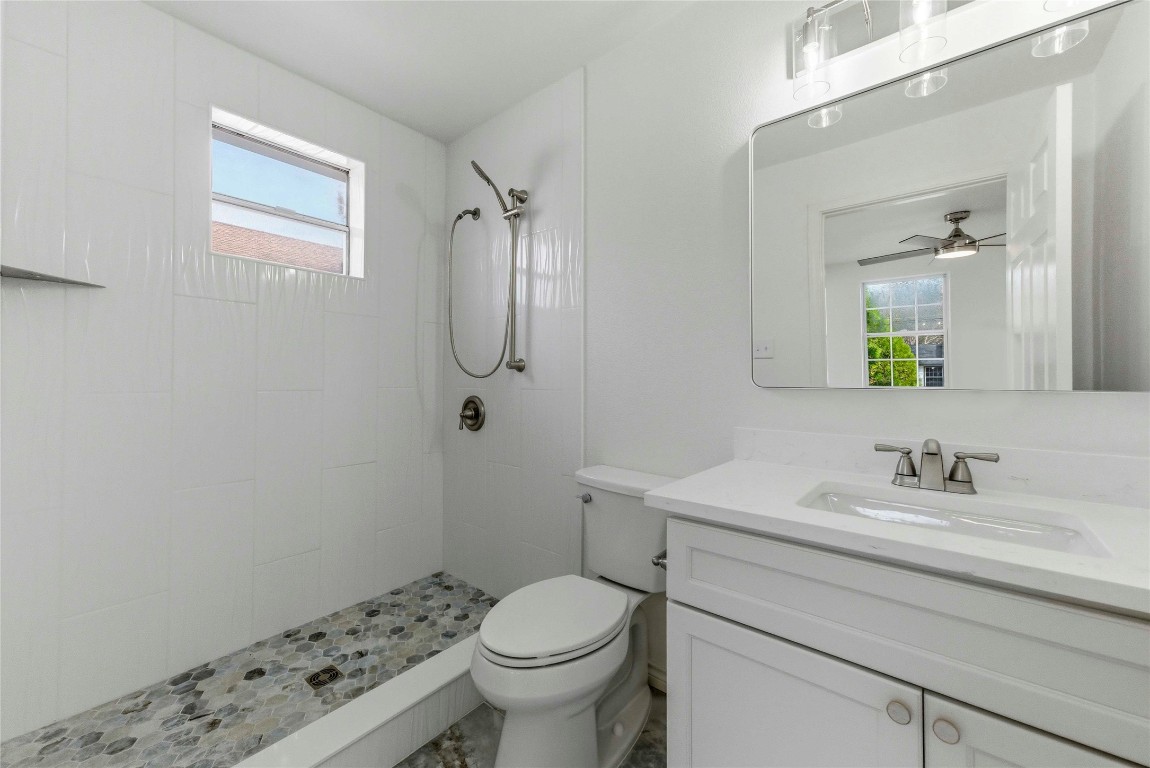 7309 Blessing Avenue Austin, TX 78752 - Photo 19 of 23 a bathroom with a sink toilet and mirror