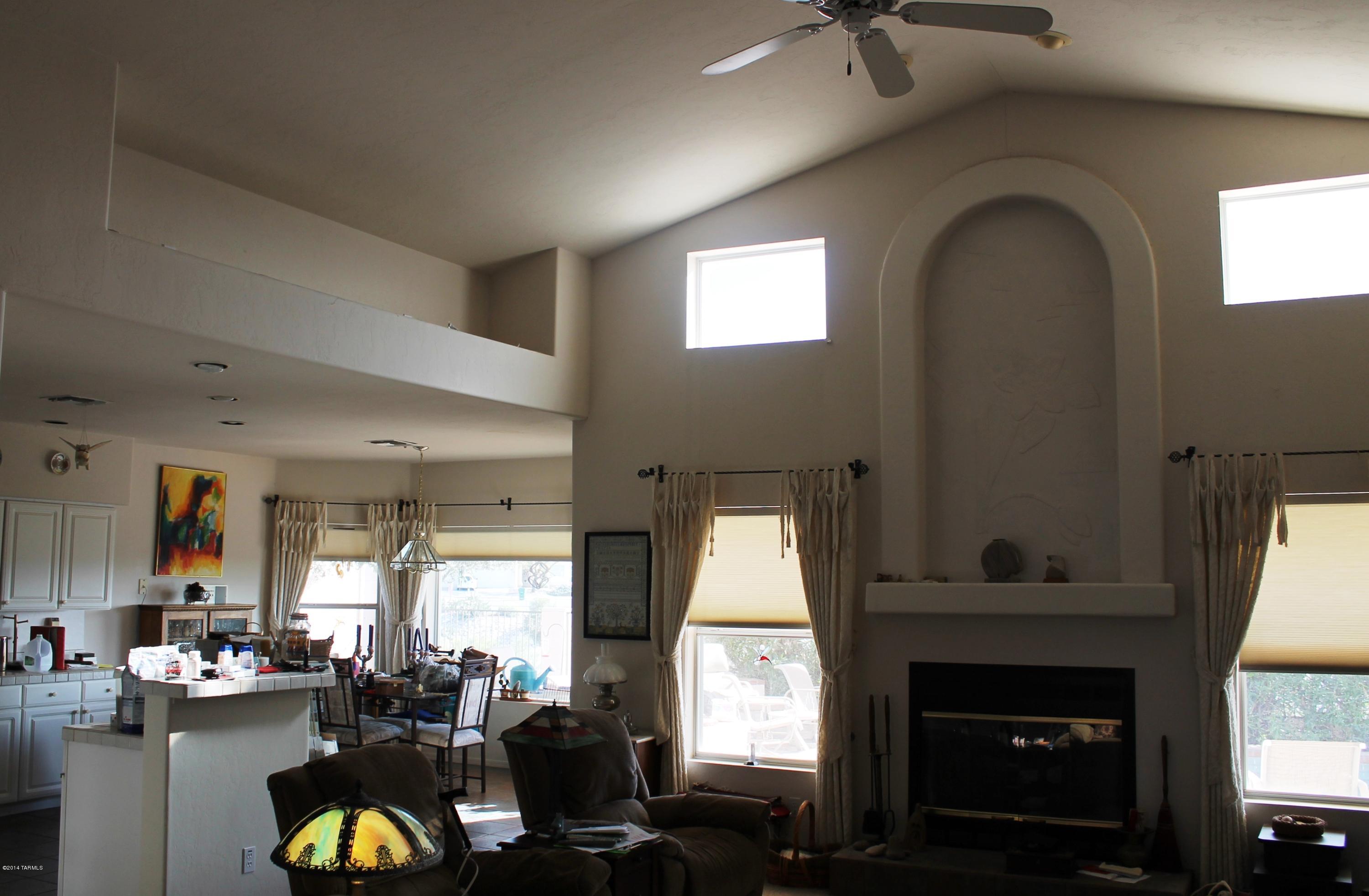 11286 North Copper Spring Trail Tucson, AZ 85737 - Photo 4 of 8 a living room with fireplace furniture and a window