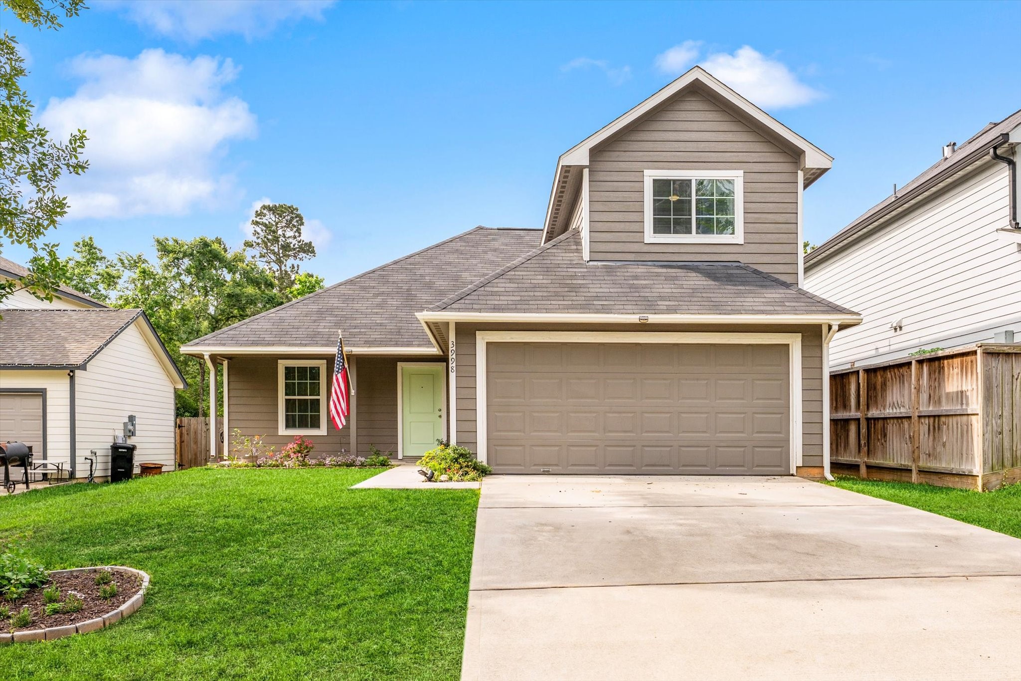 3998 Frontier Road Willis, TX 77378 - Photo 1 of 33 a front view of a house with a yard and garage