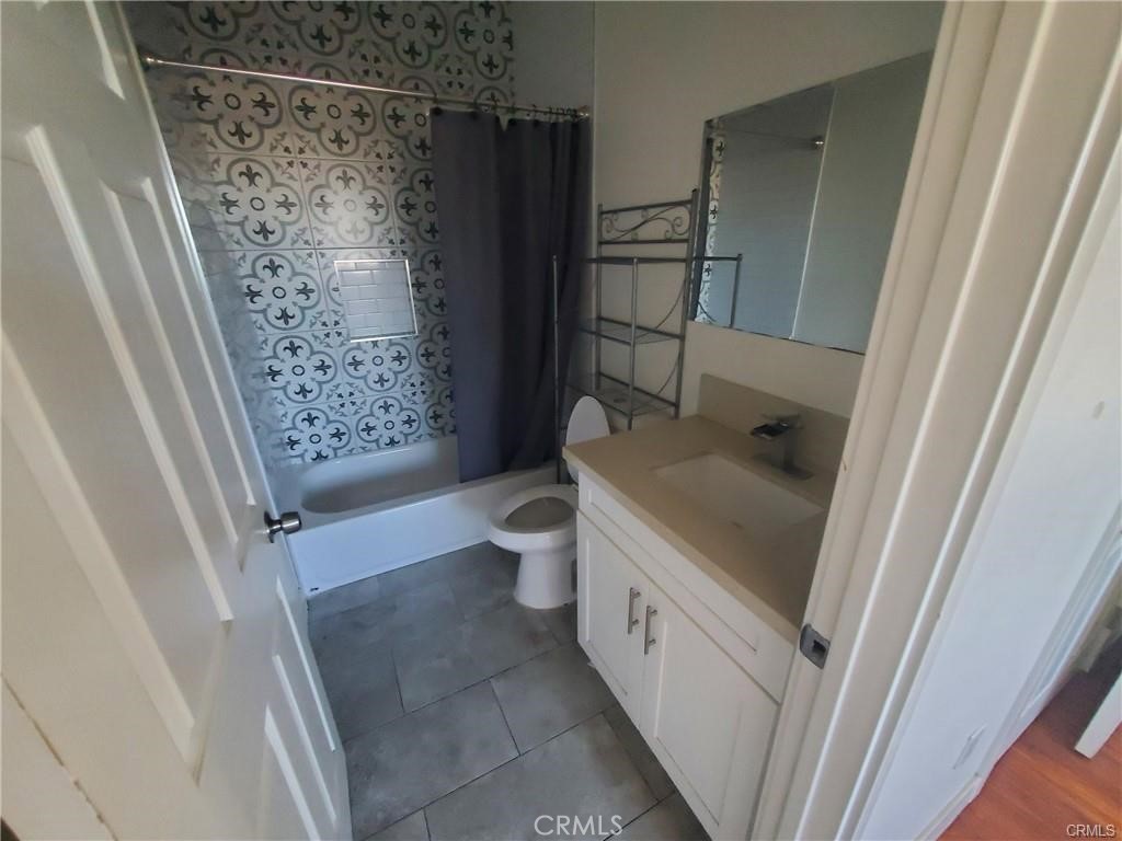 437 North Fries Avenue, Unit 1 Wilmington, CA 90744 - Photo 13 of 14 a bathroom with a granite countertop sink toilet and shower