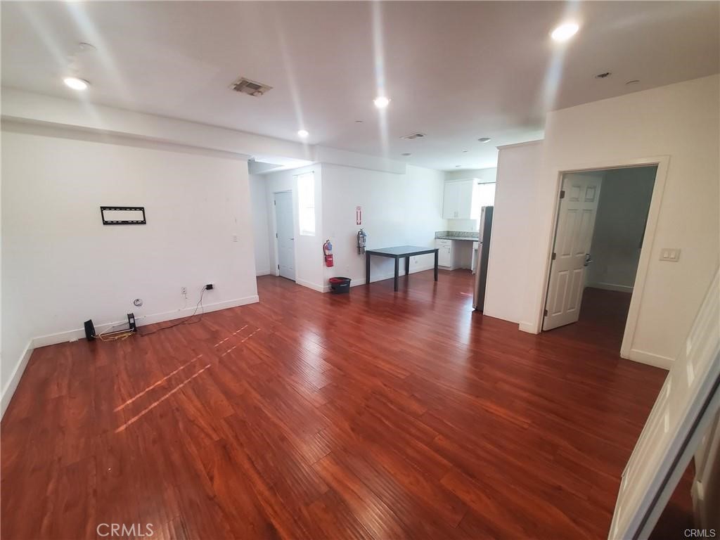 437 North Fries Avenue, Unit 1 Wilmington, CA 90744 - Photo 5 of 14 a view of empty room with wooden floor and furniture