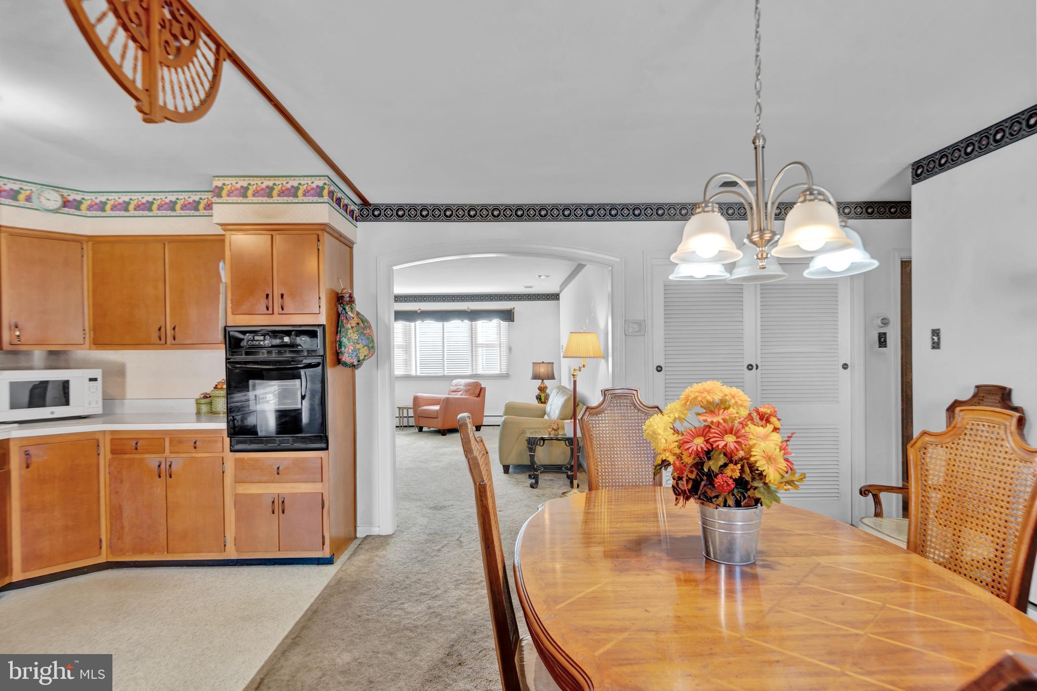 104 Gilmore Road Havertown, PA 19083 - Photo 6 of 47 a dining room with furniture a chandelier and wooden floor