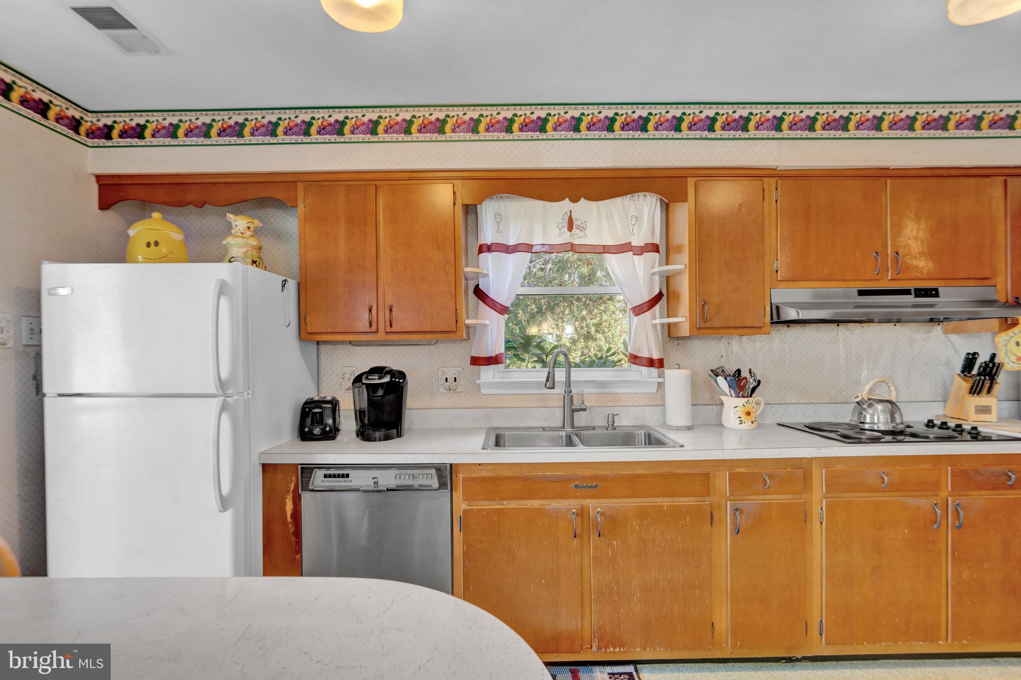 104 Gilmore Road Havertown, PA 19083 - Photo 8 of 47 a kitchen with stainless steel appliances a sink and a refrigerator