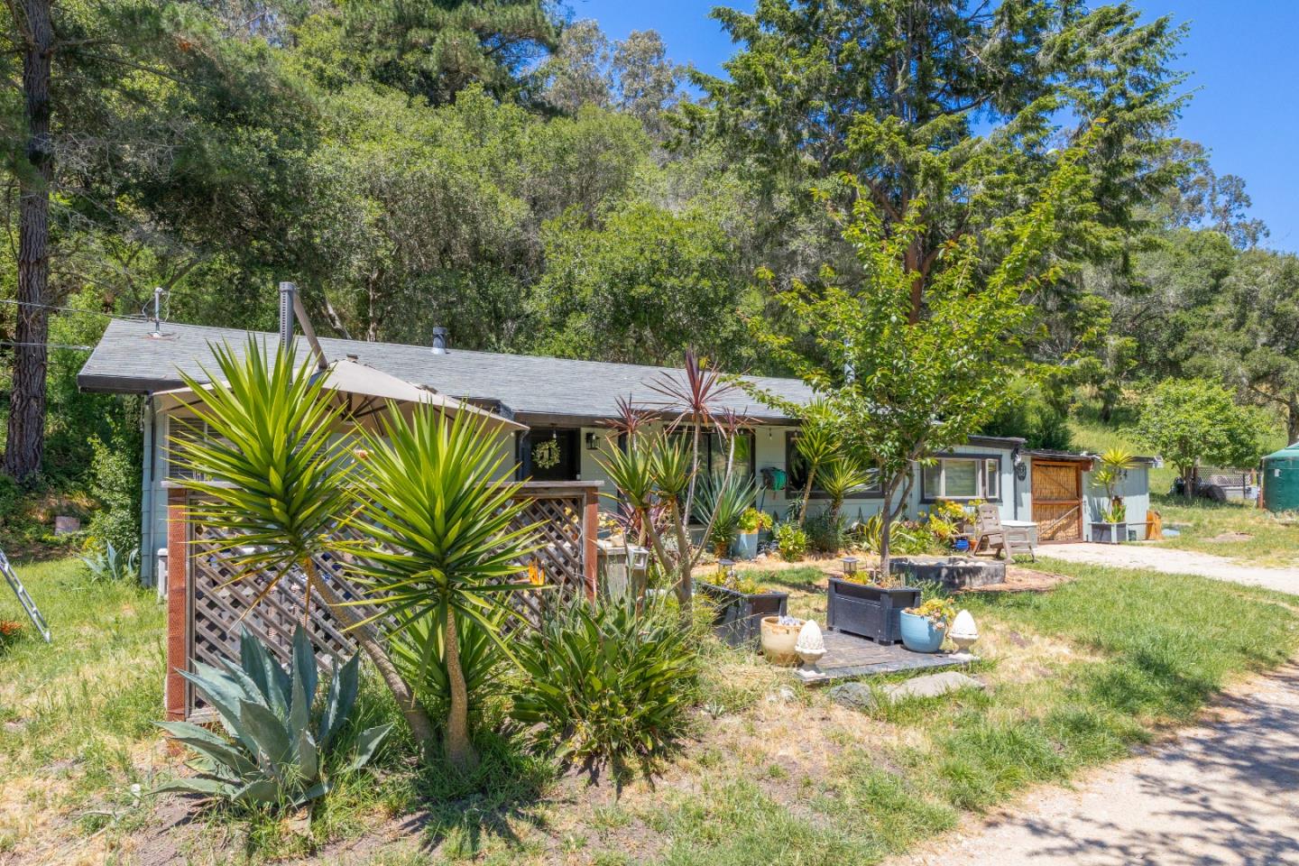 3554 Paul Sweet Road Santa Cruz, CA 95065 - Photo 25 of 30 a view of a patio with table and chairs under an umbrella